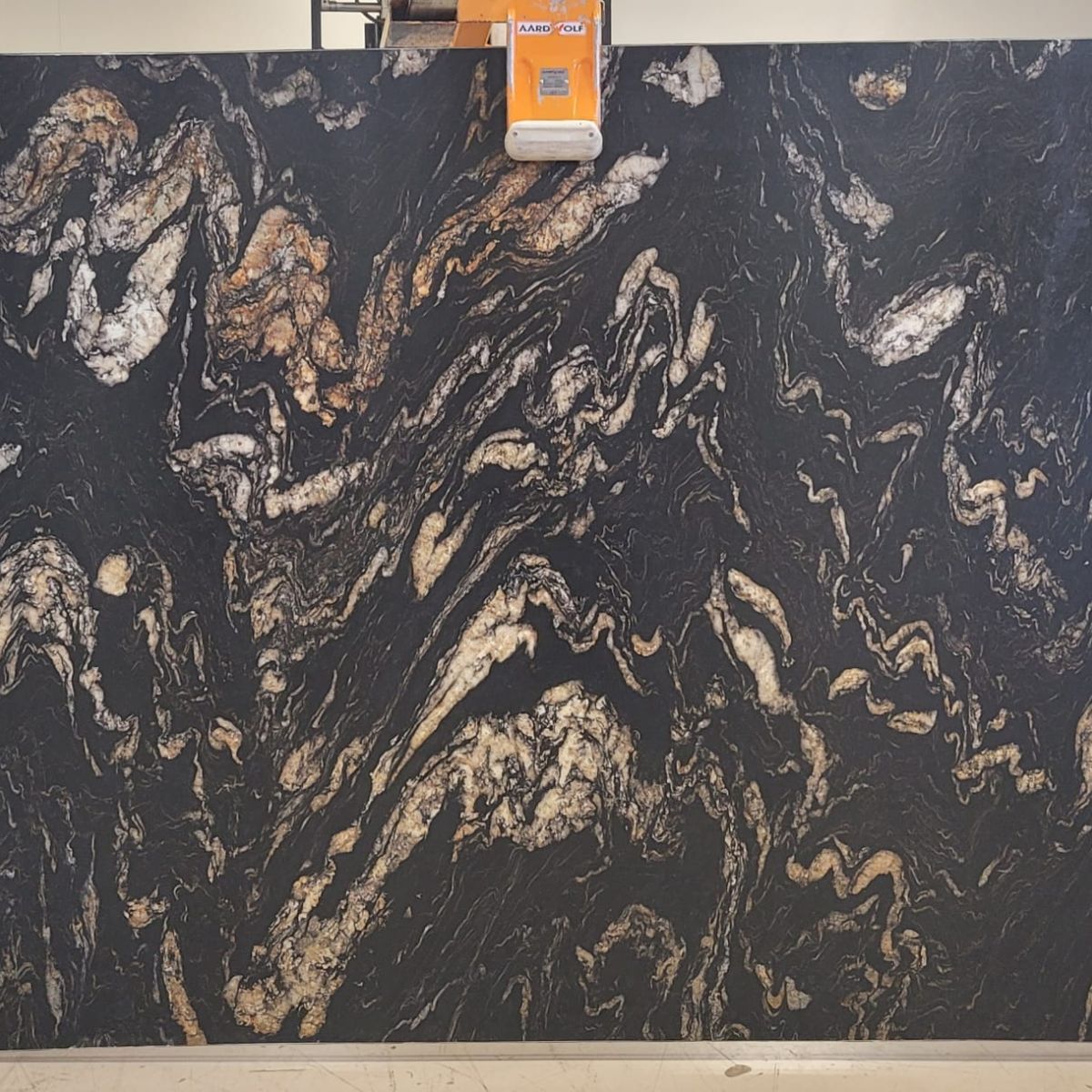 Titanium Gold Leathered Granite granite slab with deep gold and bronze movement, veining detail, StoneX USA slab gallery near Milwaukee