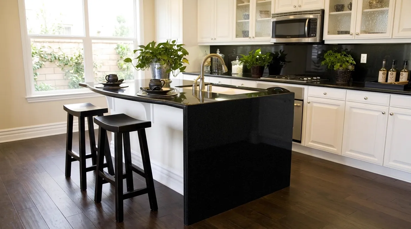 Absolute Black waterfall-edge kitchen island with continuous veining