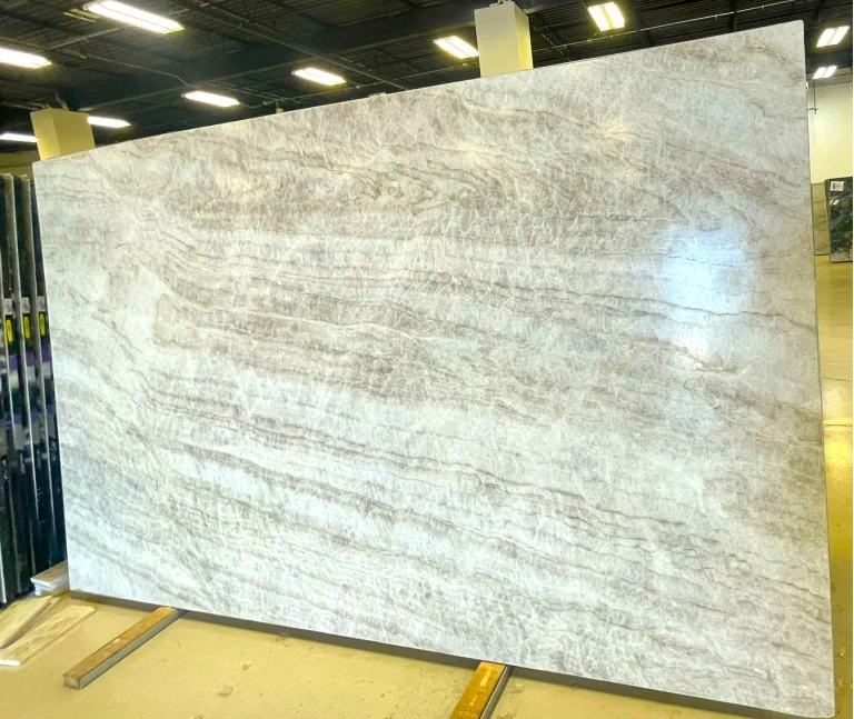 Natural Brazilian Taj Mahal quartzite slab with leathered finish, cream base and caramel veining, full slab at StoneX USA, West Allis WI